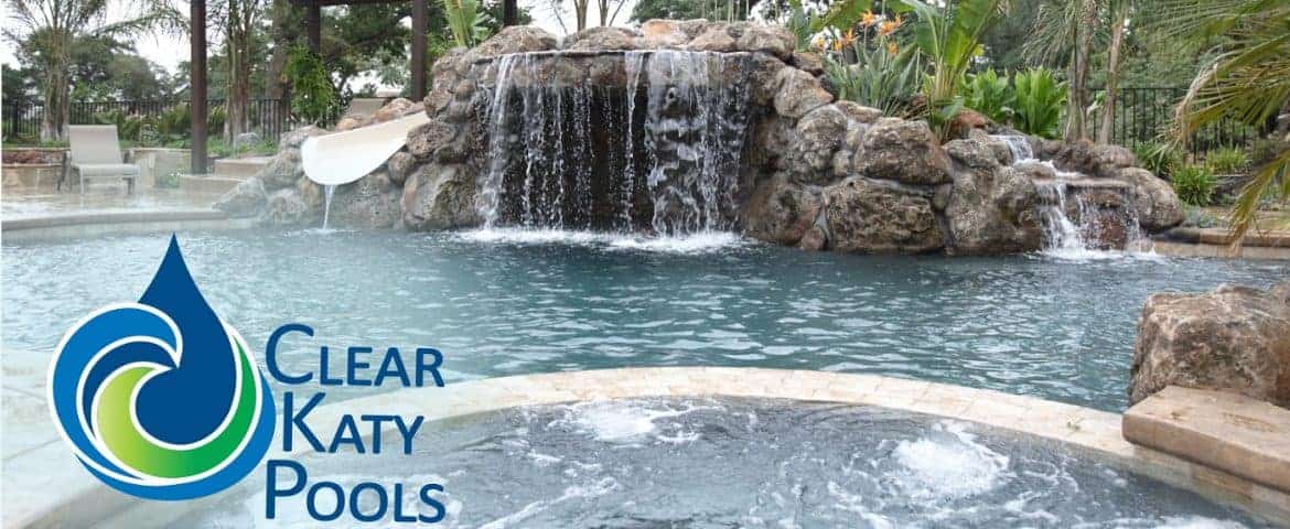 Clear Katy Pools logo on a wide shot of a waterfall and pool
